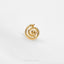 a gold spiral ring on a white surface
