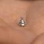 a tiny silver christmas tree ring on someone's hand