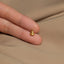 a person&#39;s hand with a tiny gold ring on it