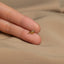 a person's hand holding a tiny gold ring