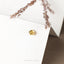 a close up of a pair of earrings on a card