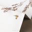 a pair of earrings sitting on top of a piece of paper