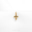 a gold cross charm on a white background