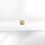 a close up of a gold brooch on a white cloth