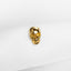 a gold skull ring sitting on top of a white cloth