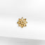 a close up of a gold brooch on a white cloth