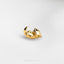 a close up of a gold ring on a white surface