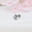 a silver cat ring sitting on top of a table