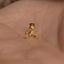 a small gold nose ring with a small gold nose ring attached to it