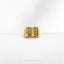 a close up of a gold ring on a white surface