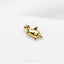 a gold giraffe brooch sitting on top of a white surface