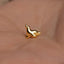 a small gold bird on a person&#39;s hand