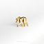 a gold brooch depicting a monkey on a white background