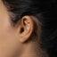 a close up of a person's ear with a piercing