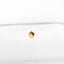 a diamond shaped object sitting on top of a white surface
