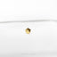 a diamond shaped object sitting on top of a white surface