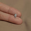 a person&#39;s hand holding a tiny silver elephant charm