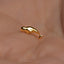 a close up of a person&#39;s hand with a gold ring on it