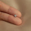 a person's hand holding a diamond ring
