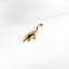 a gold brooch with a dinosaur on it