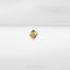 a close up of a gold ring on a white surface