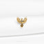 a close up of a gold bird on a white cloth