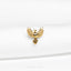 a close up of a gold bird on a white cloth