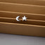 a pair of star and moon stud earrings