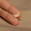 a person's finger with a tiny gold ring on it