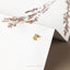 a close up of a pair of earrings on a card