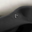 a close up of a black tie with a silver v on it