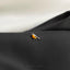 a small bird is sitting on the lapel of a suit
