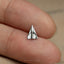 a person's hand holding a small silver origami piece