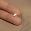 a person's finger with a tiny gold puzzle piece on it