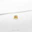 a gold crab ring on a white surface