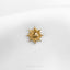 a close up of a sun brooch on a white shirt