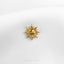a close up of a sun brooch on a white shirt