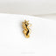 a gold sea horse brooch sits on a white cloth