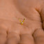 a tiny gold deer head on a person&#39;s hand