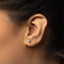 a close up of a person wearing a pair of ear piercings