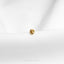 a small gold ring sitting on top of a white cloth