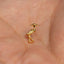 a close up of a person&#39;s hand with a small bird charm on it