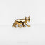 a close up of a gold colored animal brooch