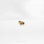 a close up of a gold ring on a white surface