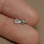 a person&#39;s finger with a silver ring on it
