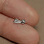 a person&#39;s finger with a silver ring on it