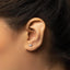 a close up of a person wearing a pair of ear piercings