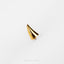 a gold ring on a white surface