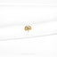 a close up of a white shirt with a gold brooch