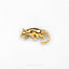 a gold brooch with a small animal on it